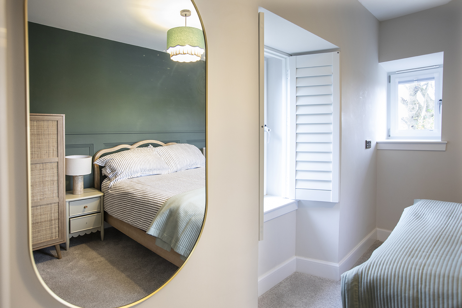 Master bedroom reflected in mirror